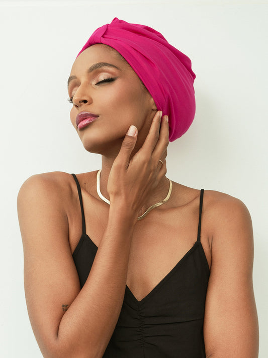 Bright pink women's turban head wrap. Overnight hair wrap to protect the hair at night. Wake up to frizz free hair with our pre-tied satin-lined hair wrap